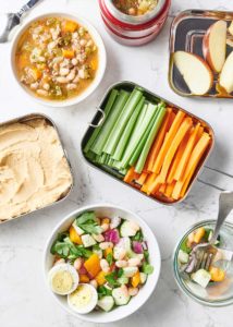 Various snacks and lunch on a marble countertop surface